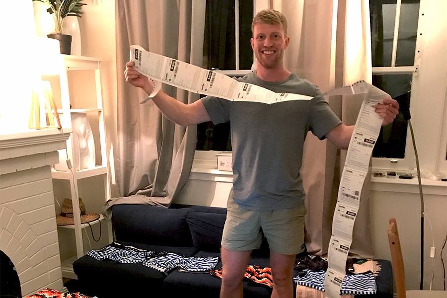 Patrick Psotka holding a string of order invoices