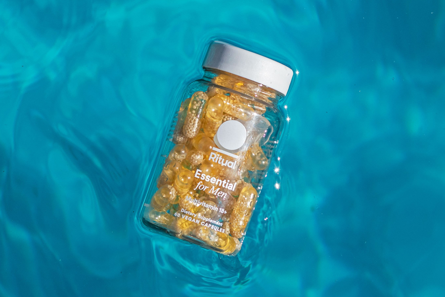 Bottle of Ritual Multi-vitamin capsules floating in water