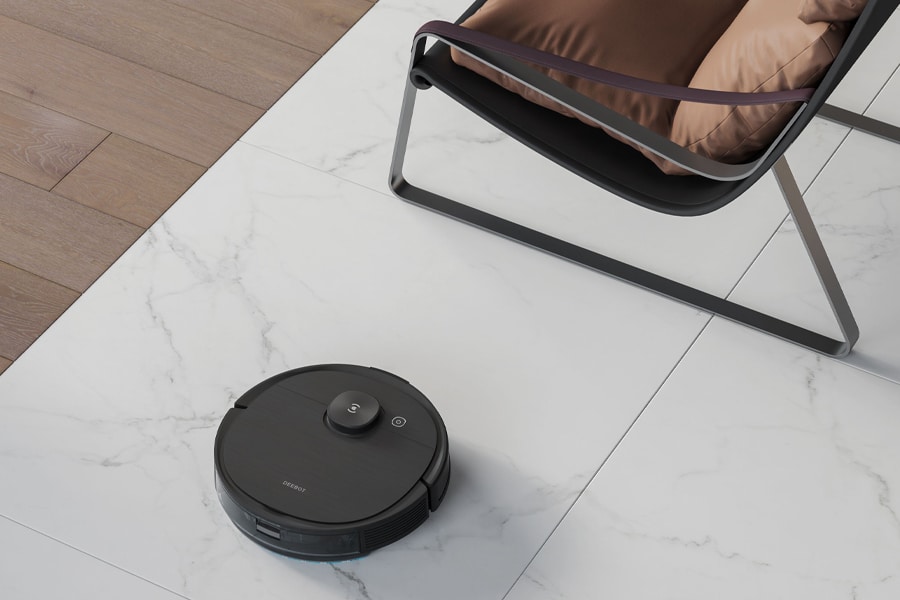 Ecovacs Deebot Ozmo T8 at feet of a chair