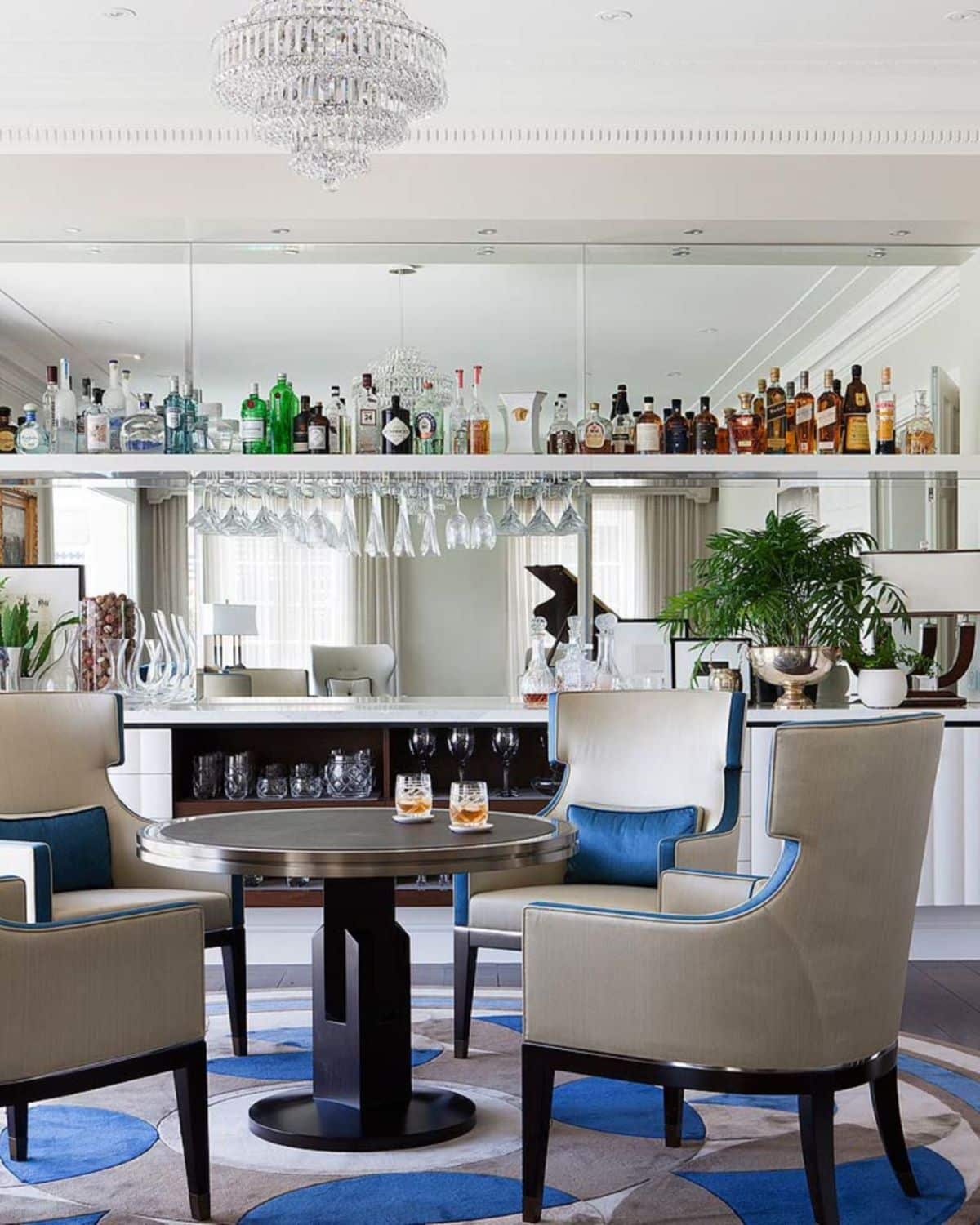 A table with filled glasses in front of the bar of Molecule Architecture's Wayne Residence