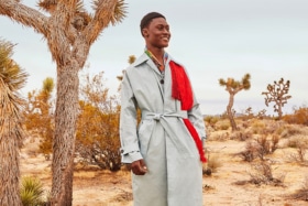 A model in a Farfetch trench coat