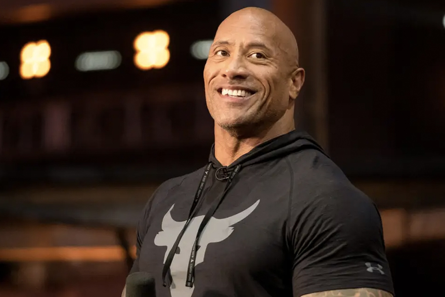 Close up of The Rock smiling in tight underarmour shirt