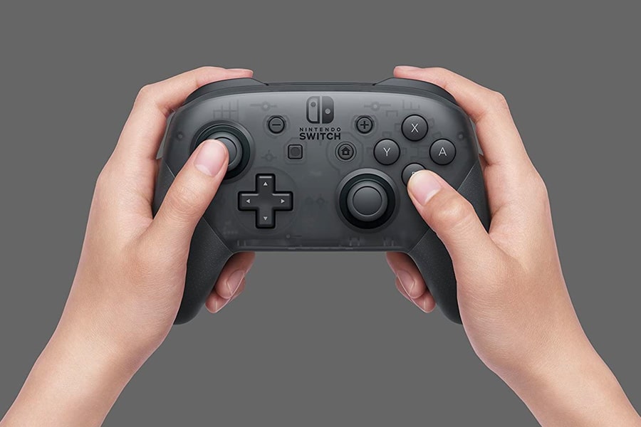 Nintendo Switch Pro Controller in a pair of hands