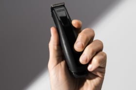 A hand holding JRL FreshFade 1040 Black Clipper