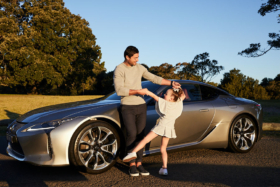 Anthony Minichiello playing with his daughter near his Lexus