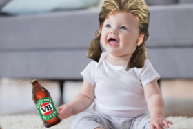 A baby edited with long-hairs holding a Victoria Bitter bottle