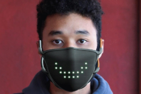 A man wearing a Jabber Mask with a wide smile made by LEDs