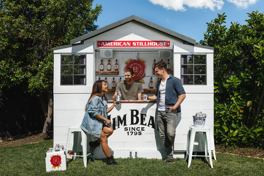 Three people at Jim Beam Stillhouse with cans