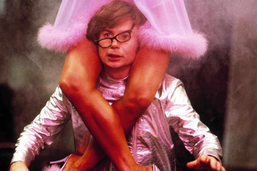 A woman sitting on shoulders of Austin Powers from movie