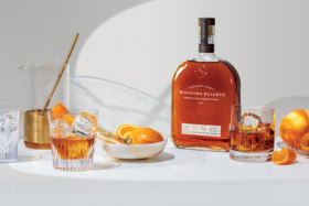Woodford Reserve Whiskey bottle with oranges and cocktail