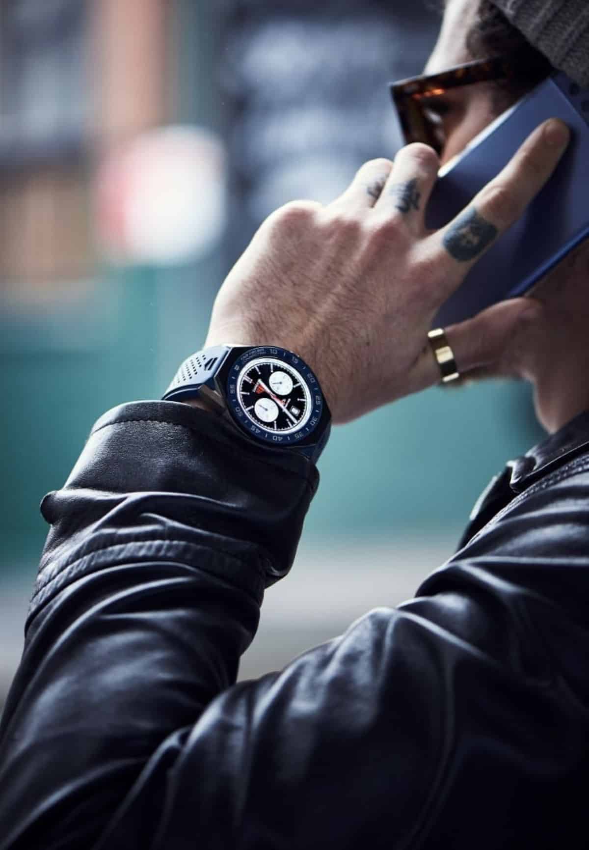 A man talking on a phone with TAG Heuer Connected 45 on his wrist