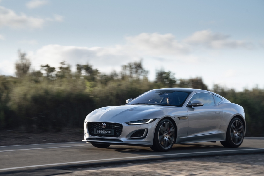 Side view of the silver 2021 Jaguar F-type, driving on the road