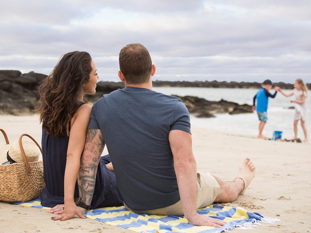 couple with kids resting on killarney beach