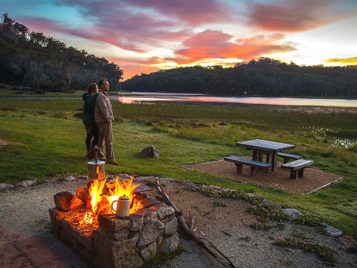 couple near camp fire at lake catani mount buffalo