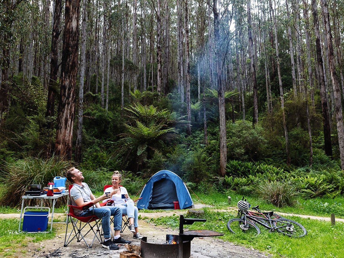 couple camping in the forest near lake elizabeth great otway national park
