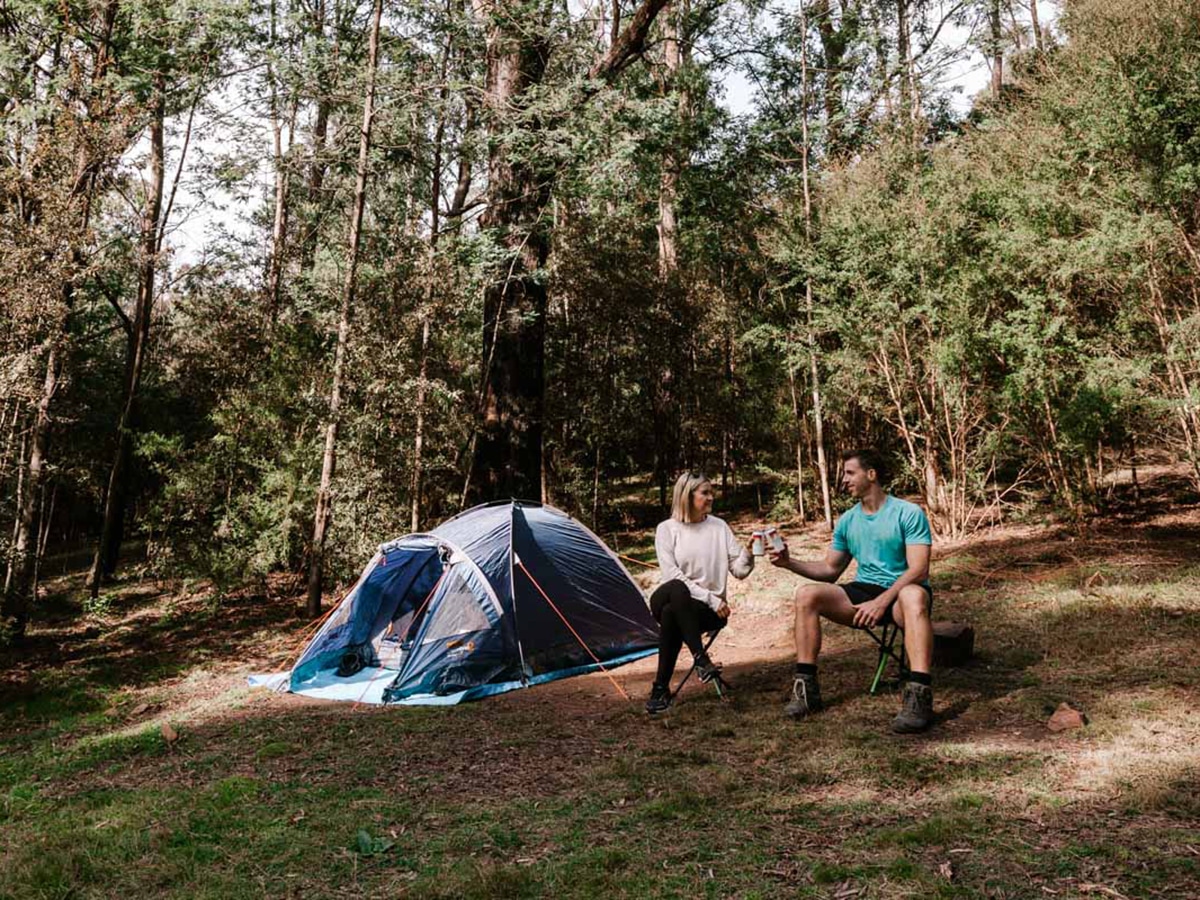 Young Couple Camping In The Forest