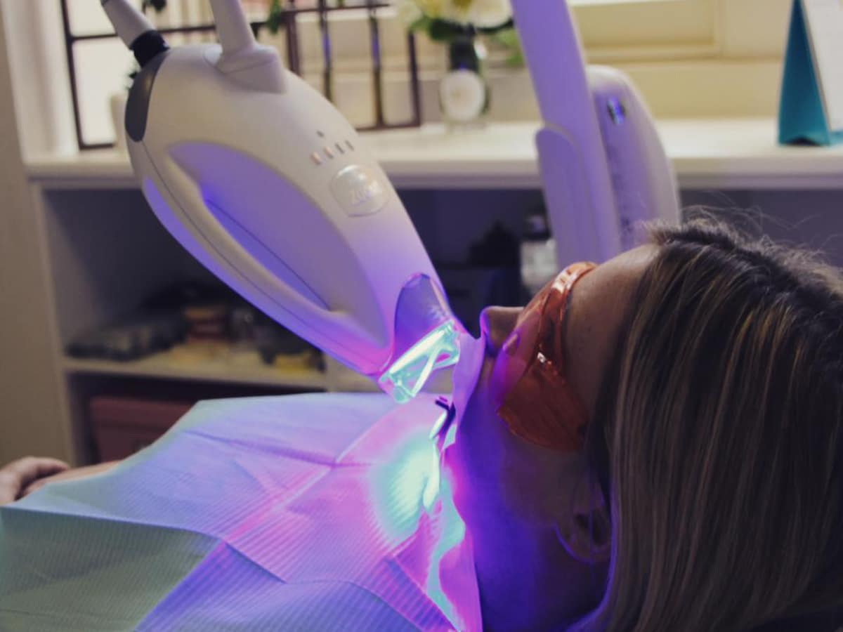 woman getting teeth whitening treatment at gorgeous smiles