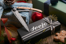 A Deejo knife with a Deejo box with a ribbon