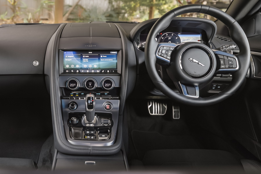 Landscape view of the 2021 Jaguar F-type showing the steering wheel and car controls