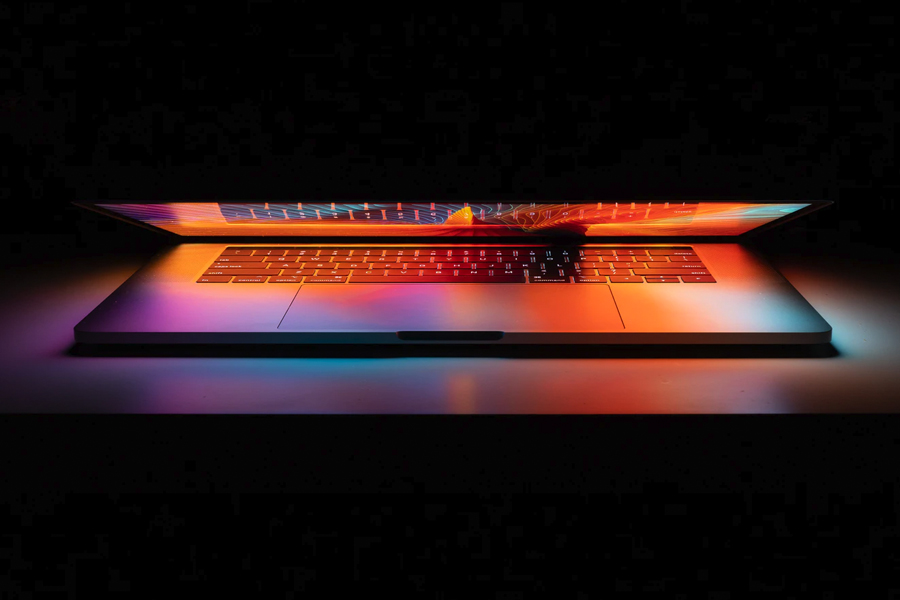 A half-open laptop with mutlicolour lights inside