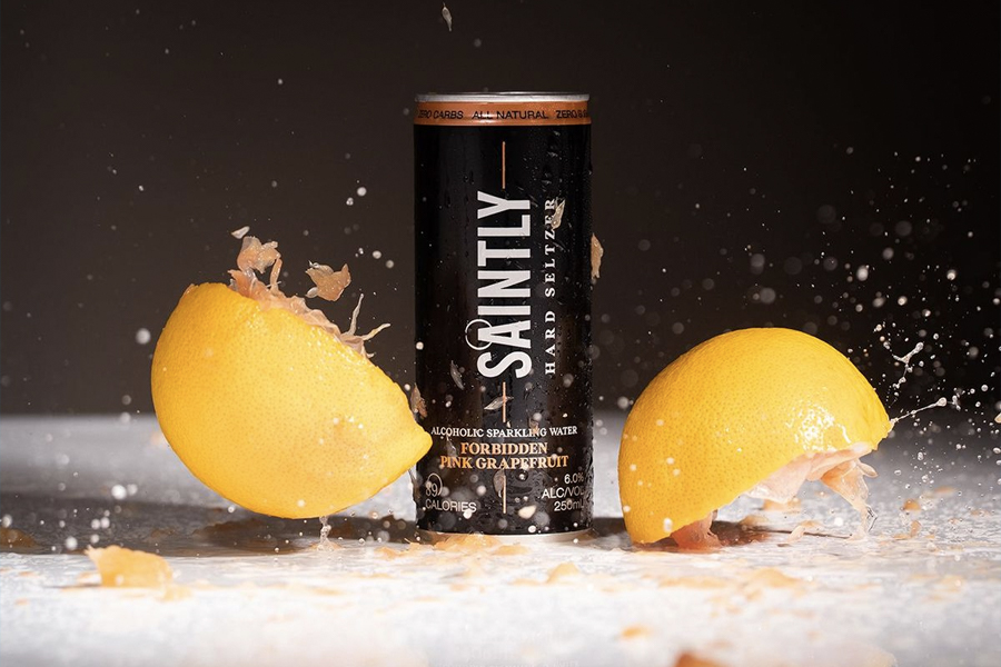 Can of Saintly with lemon halves on both sides