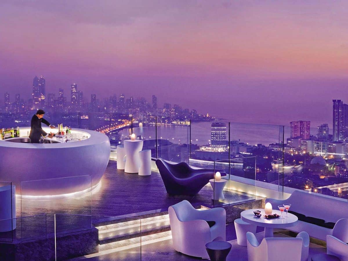 Bartender in circular bar at Aer rooftop bar Mumbai