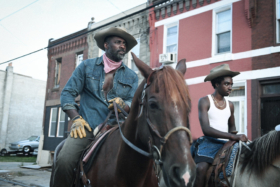 Idris Elba and Caleb McLaughlin riding horses from Concreye Cowboy