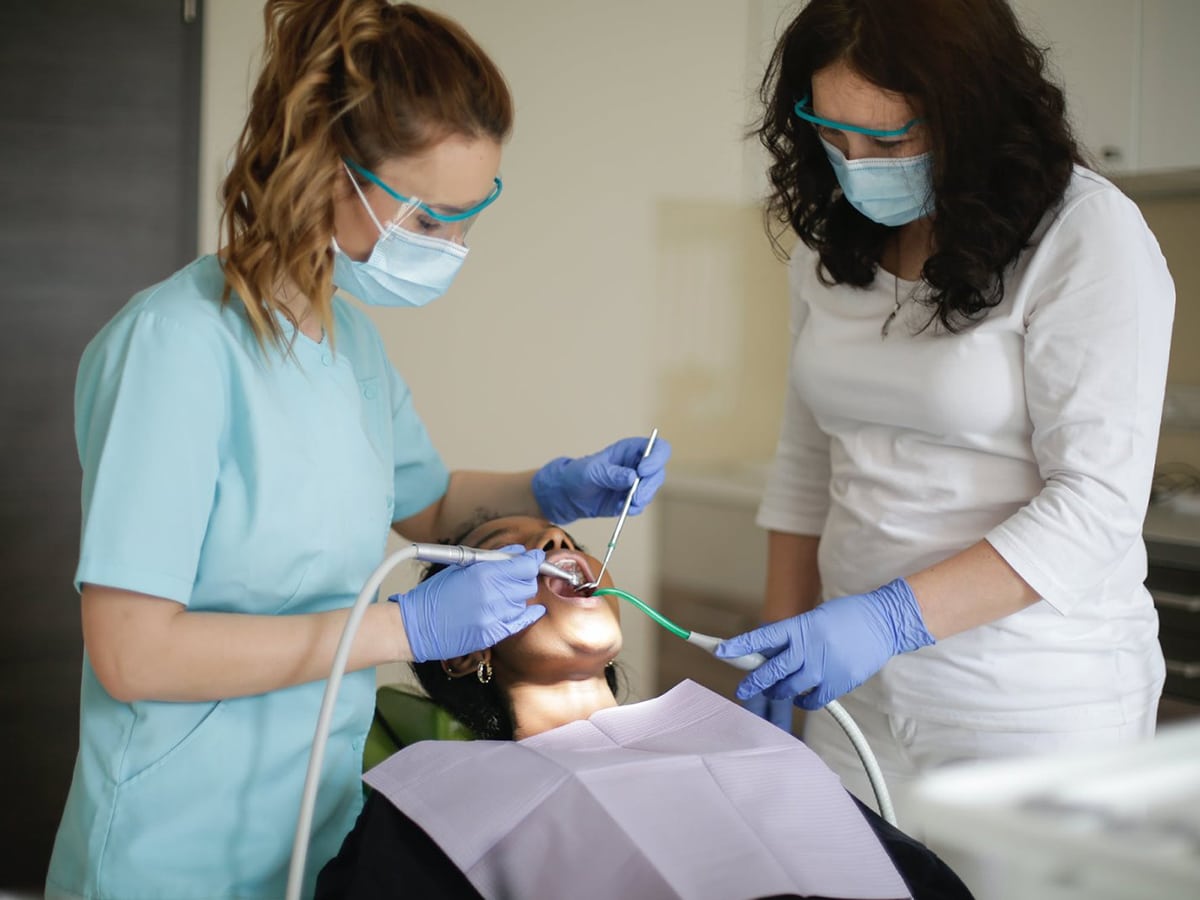 doctor treats patient teeth at smile bar