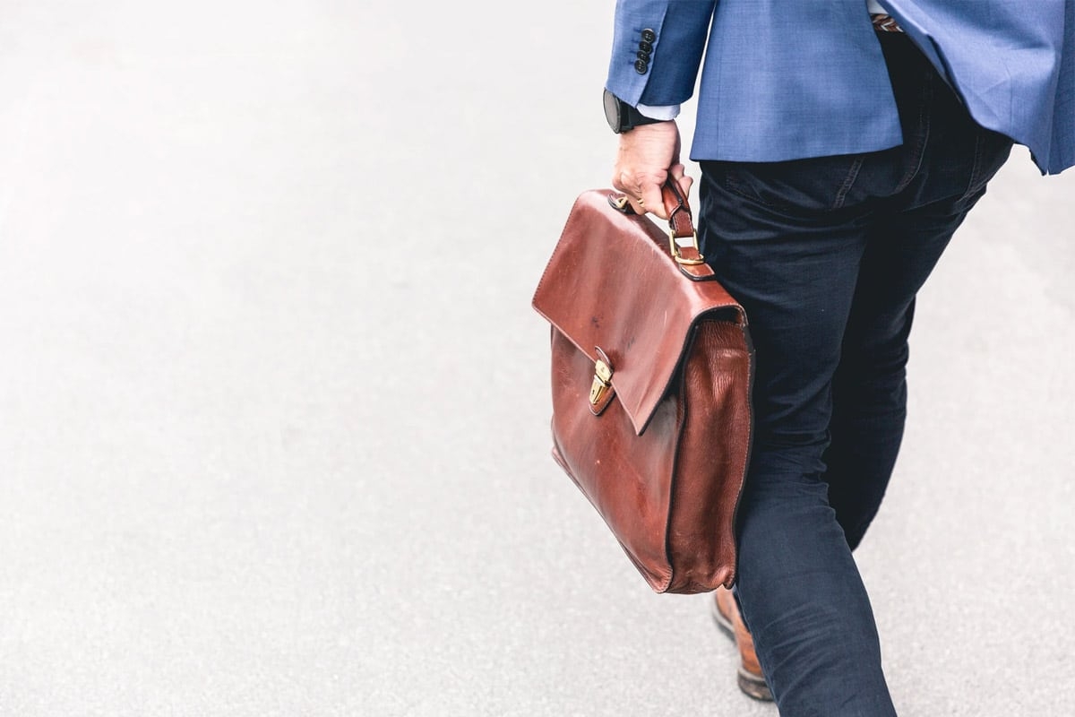 A man with a leather office bag