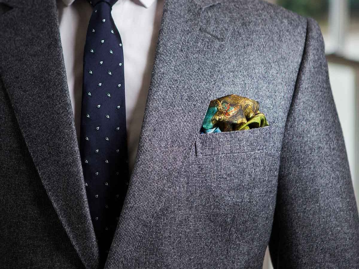 A man in a grey suit with Puff Pocket Square