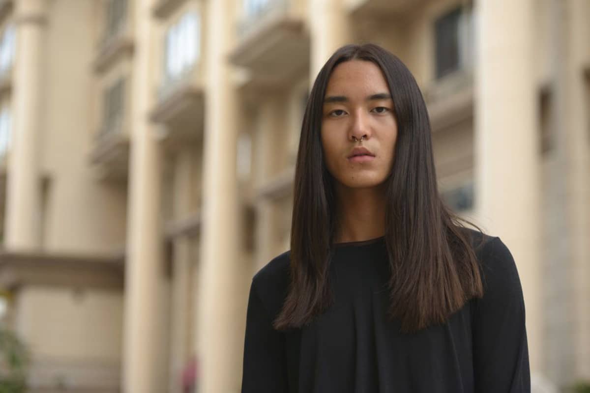 Model with men's middle part hairstyle long straight curtains | Image: iStock