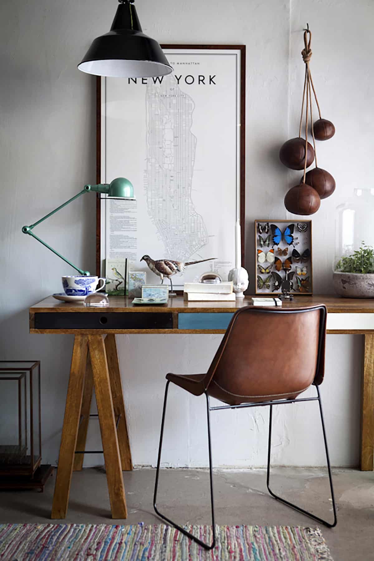 Wooden desk with showpieces on it and brown chair in front of it