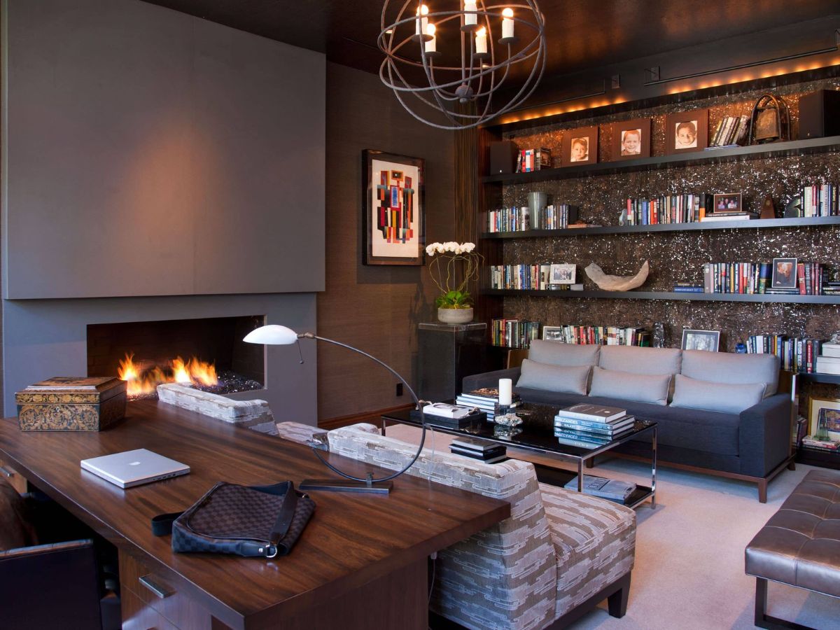 Living room with wood desk and shelves on wall opposite wall