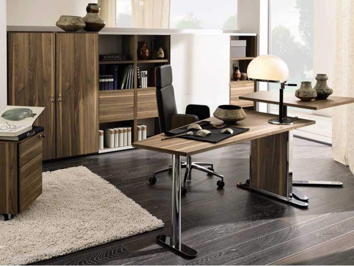 Masculine office with wood top desk and black office chair behind