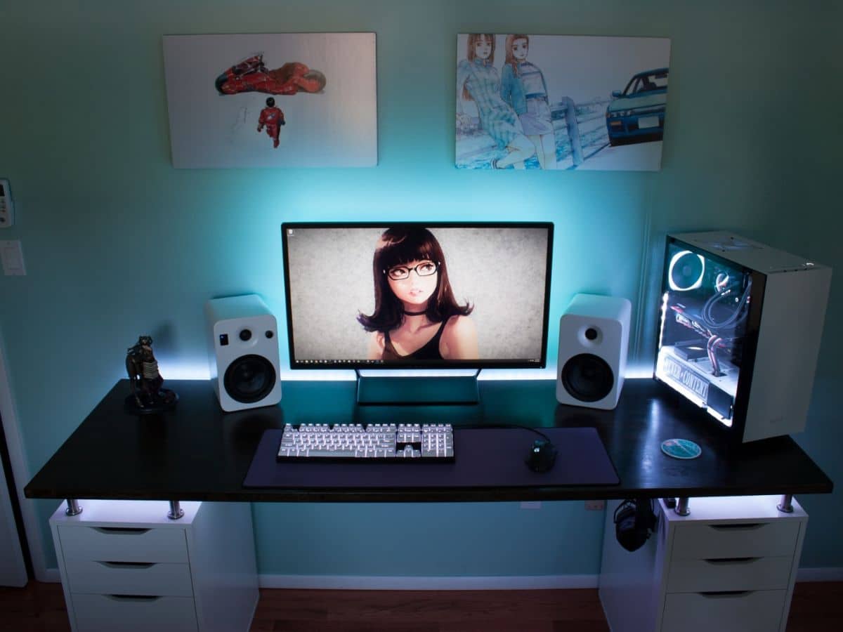 Desk with a blue light behind monitor