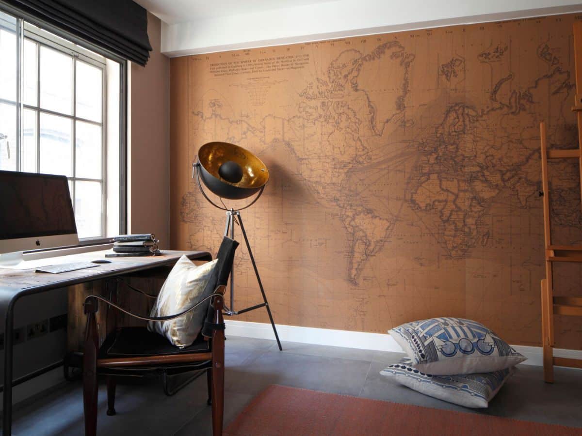 Home office with table along a window and a large world map on a side wall