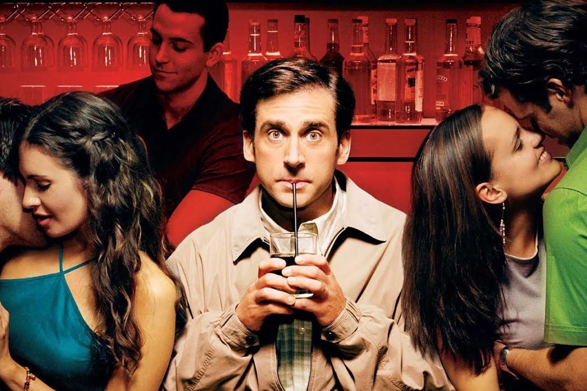Steve Carell drinking with a straw at a bar  as two couples make out on his sides in a poster from The 40-year-old virgin 