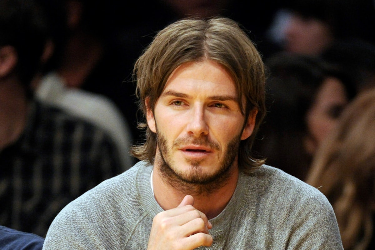 David Beckham with a long middle part hairstyle | Image: Harry How/Getty Images