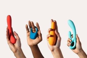 Four hands holding sex toys
