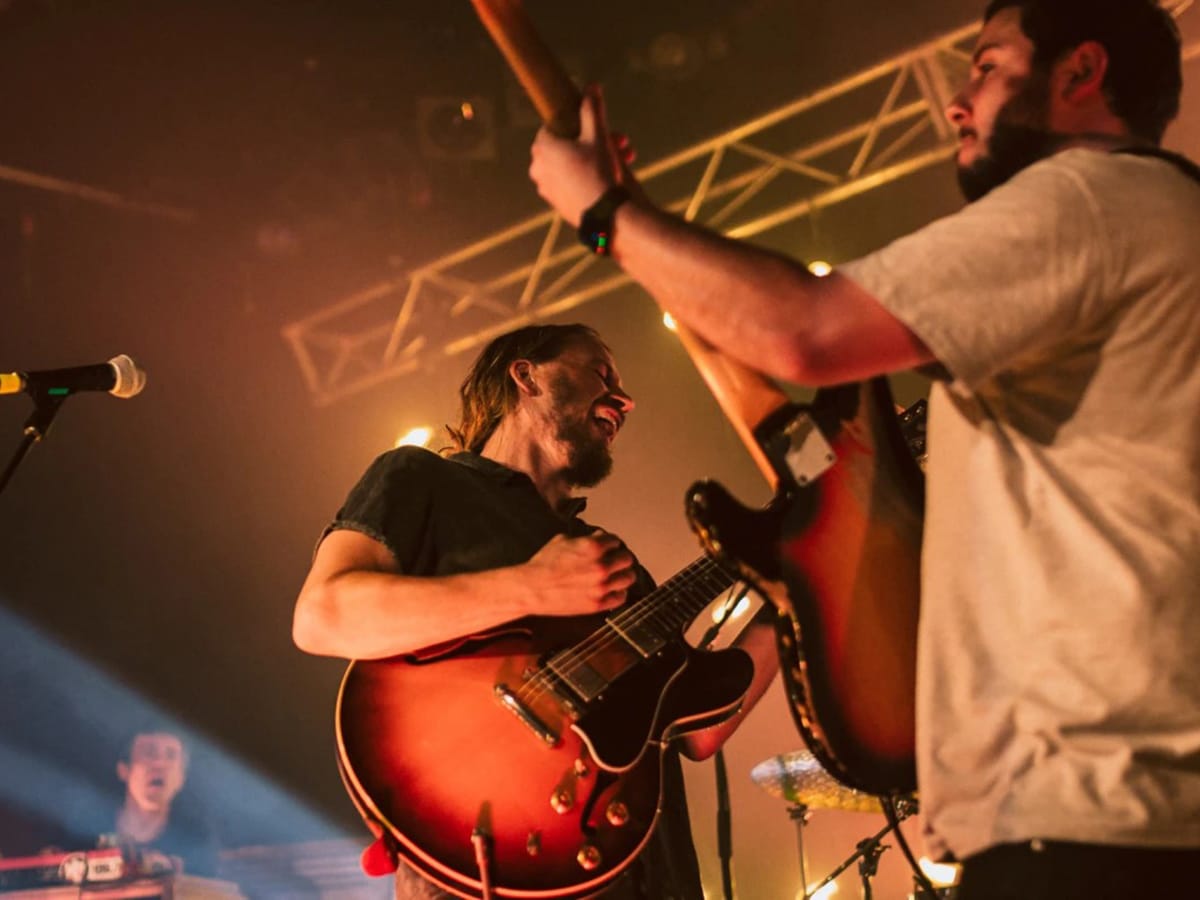 two men playing guitar