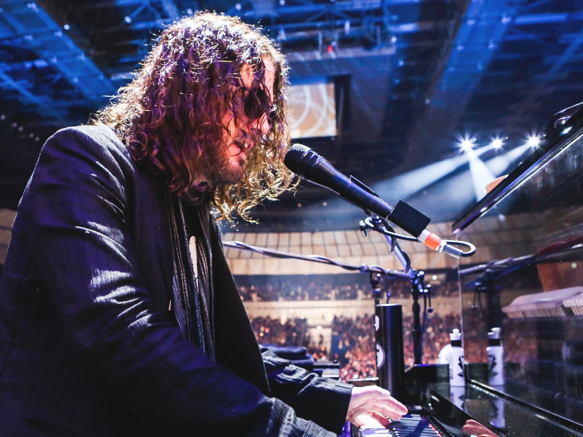 man playing grand piano at live concert