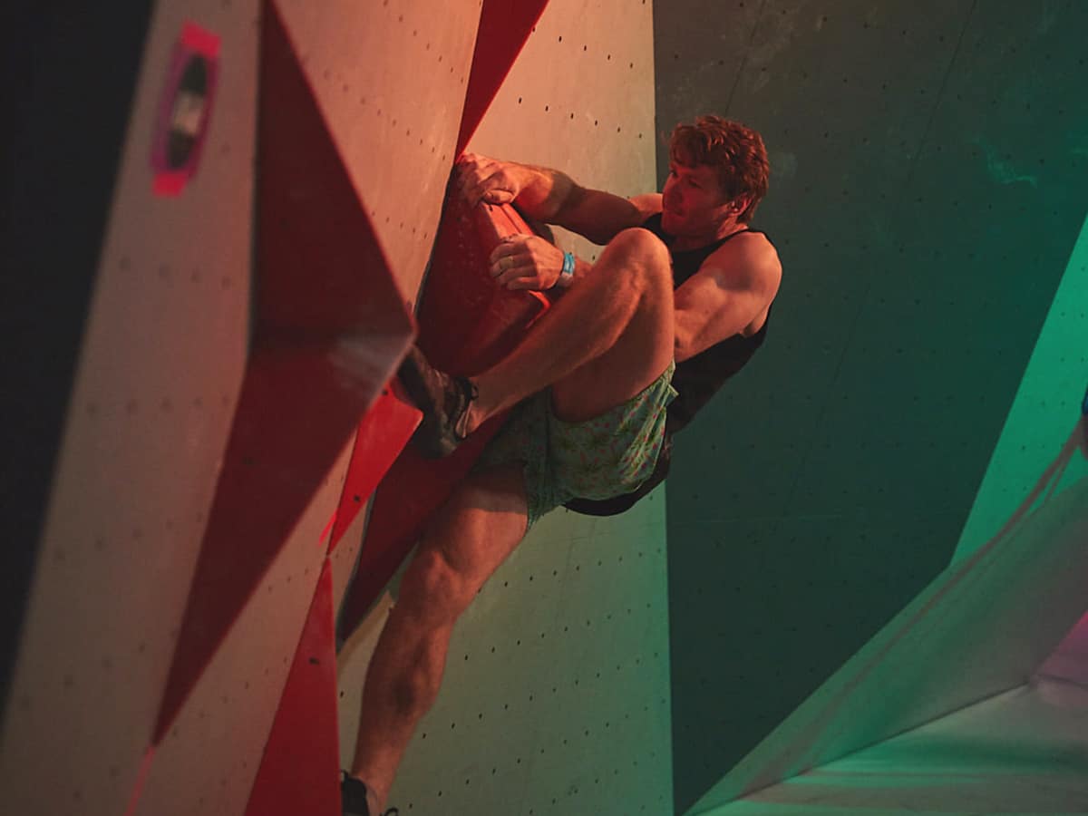 man climbing wall in boulder lab rock climbing gym