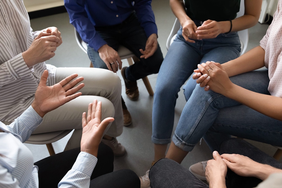 Circle of people sitting on chairs