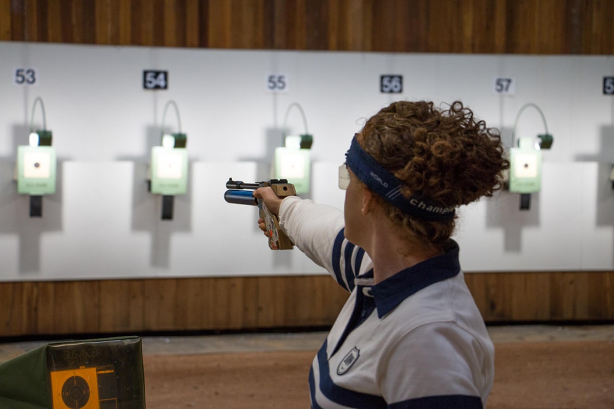 Woman aiming gun in sydney international shooting centre