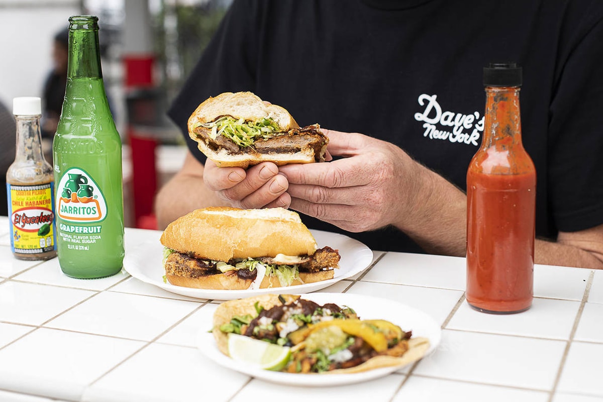 man holding tacos at frankies tortas and tacos