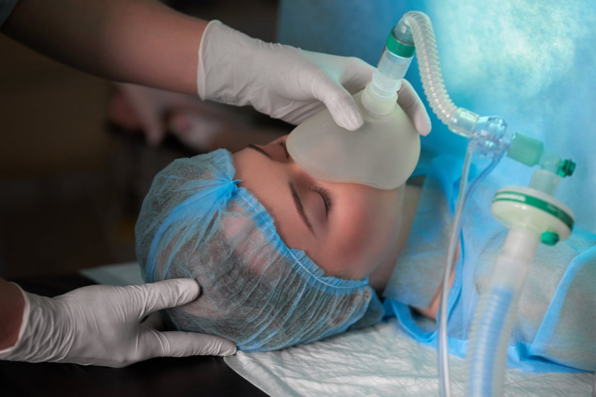 anaesthetist holding mask over patients mouth