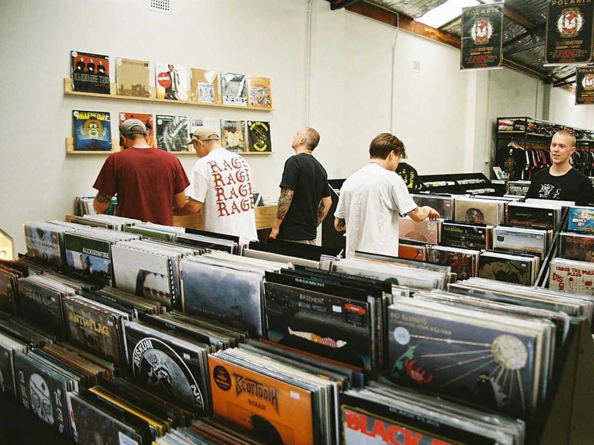people choosing vintage vinyl at resist records