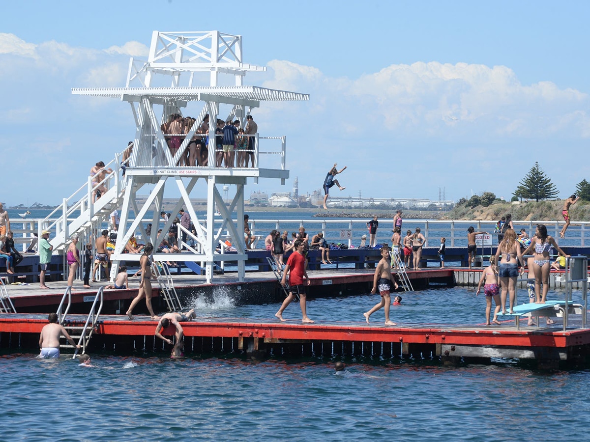 people on a diving platform on the eastern beach