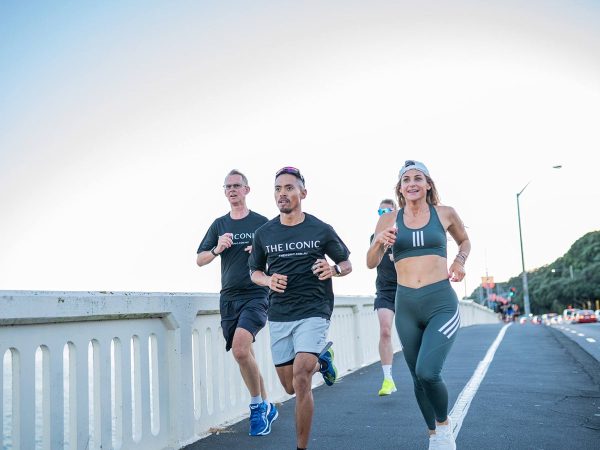 people running over the bridge in the iconic sports clothing