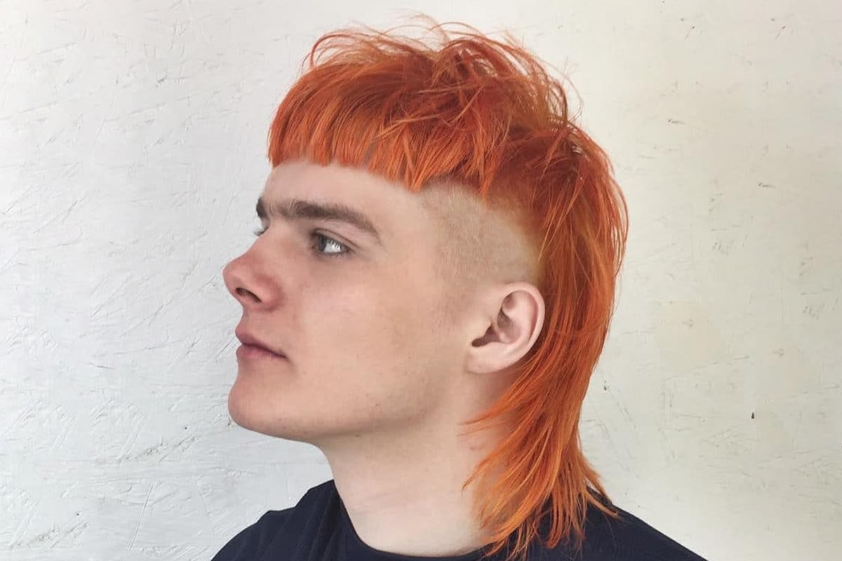 a red-haired guy with orange hair in a ponytail video